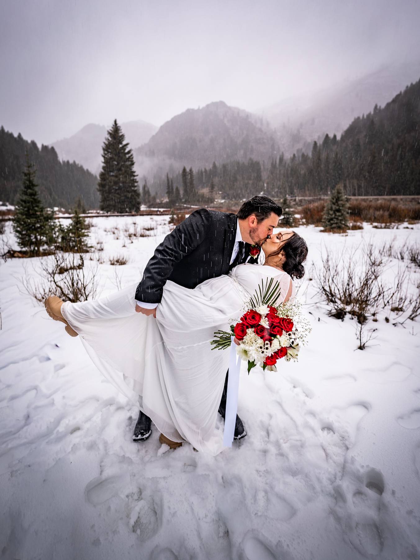 Couple doing dip in snowy cottonwood canyon utah elopement